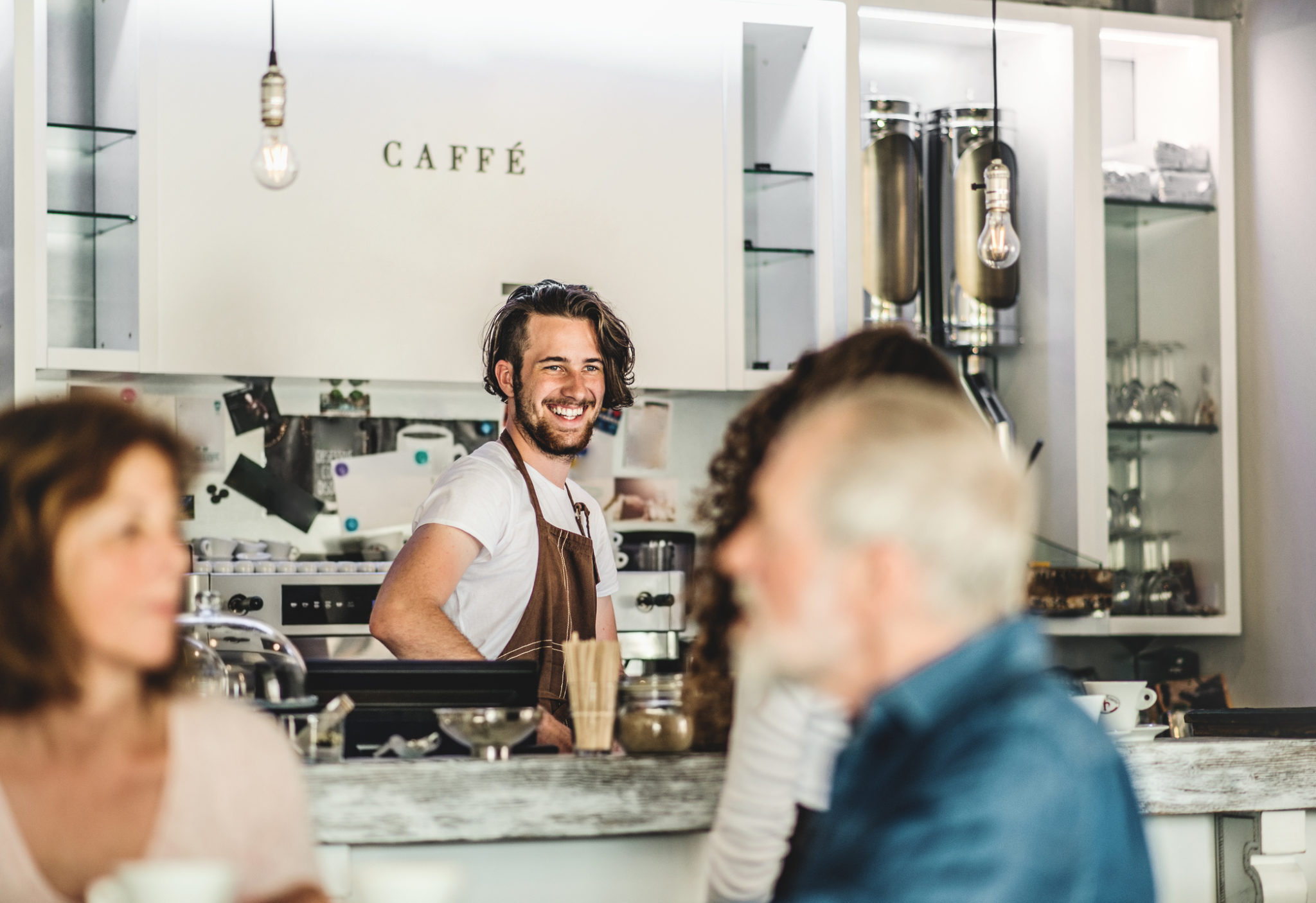 Happy Barista Serving Customers