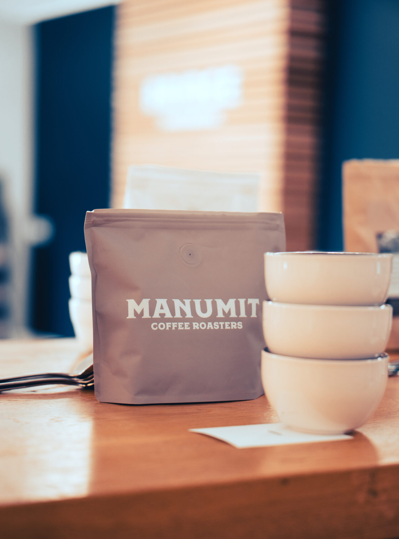 A bag of freshly roasted coffee beans roasted in Wales by Manumit Coffee Roasters ready to be tasted